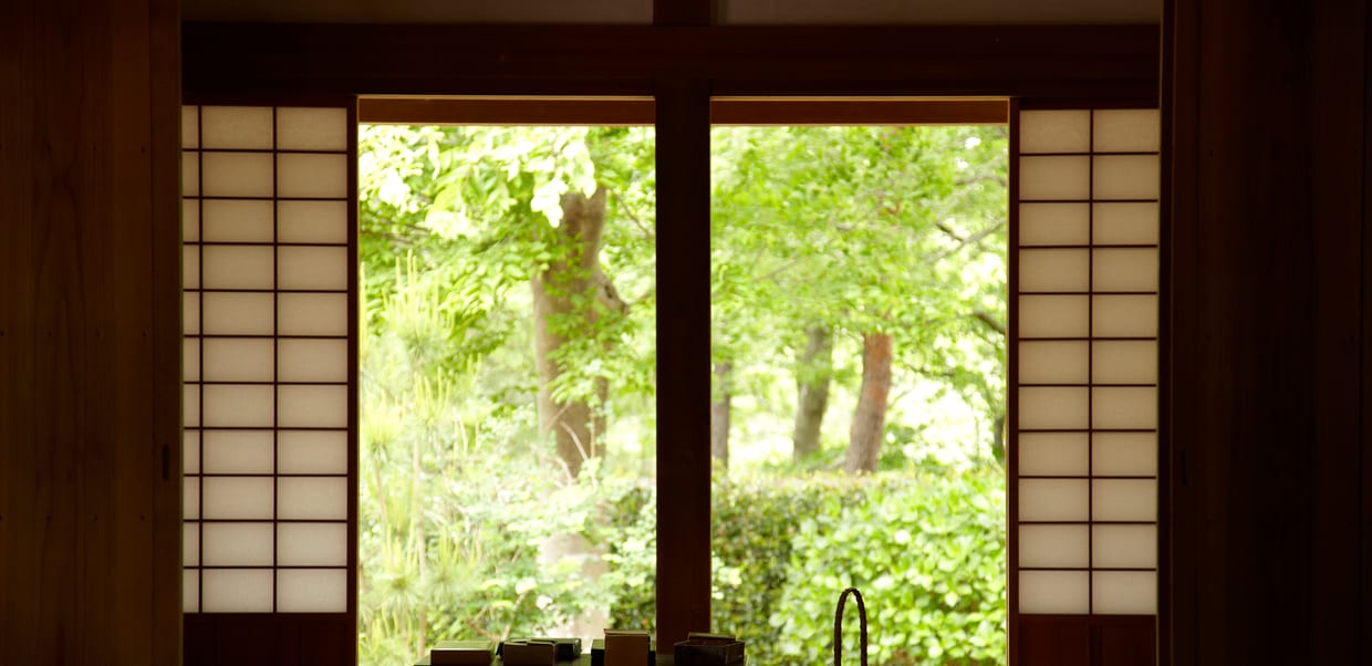 A tatami room, shoji screens framing the light beyond