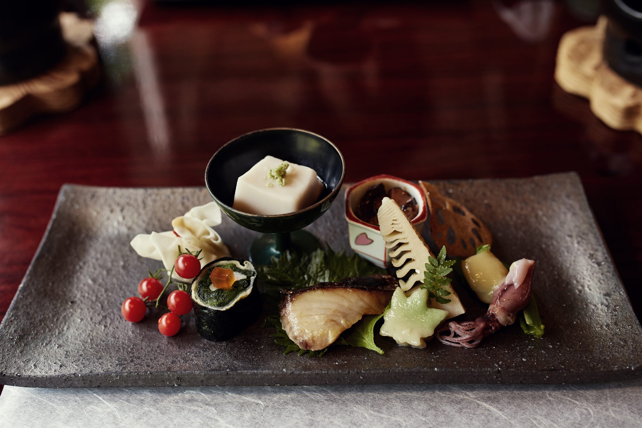 An elegant kaiseki course of tofu and grilled fish on small dishes