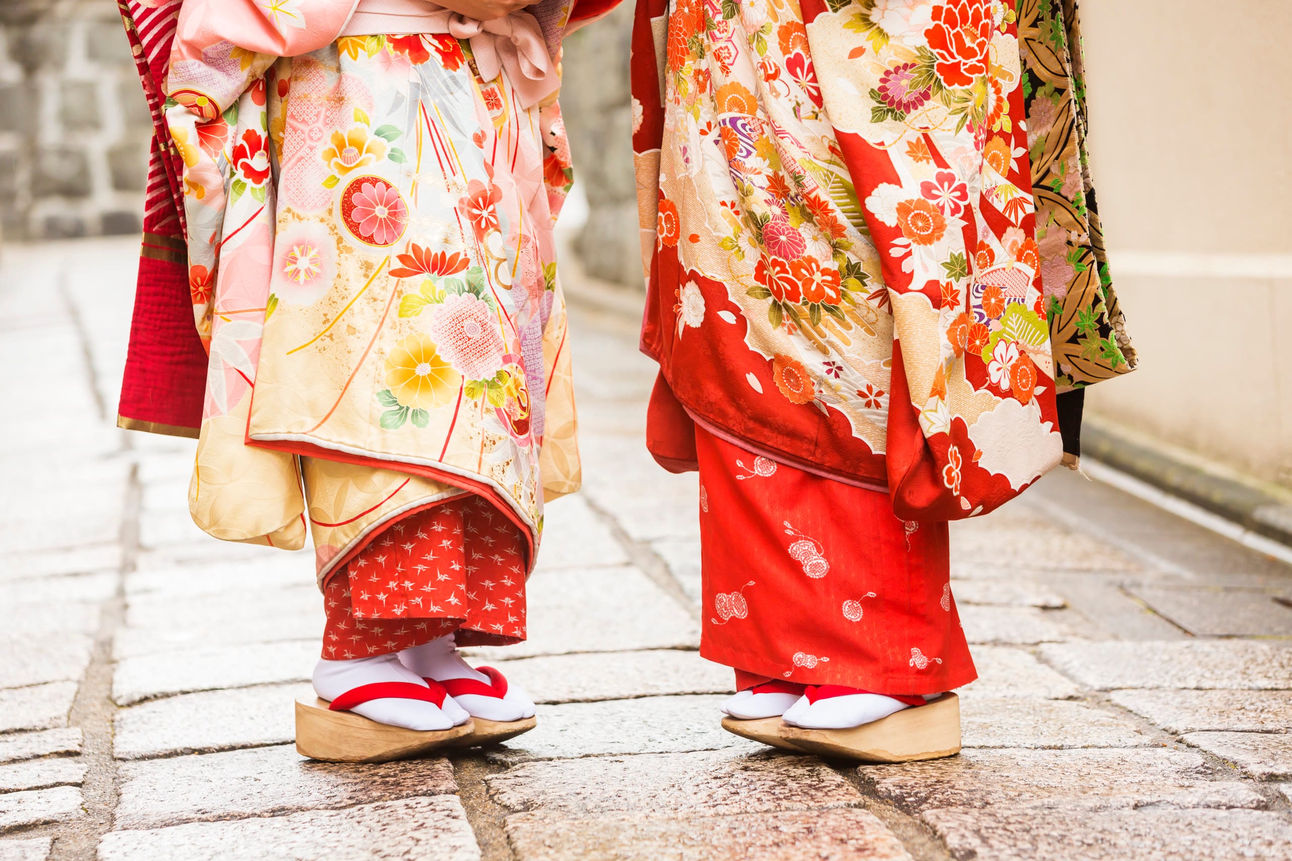 Wooden geta sandals resting on a stone lane in Kyoto