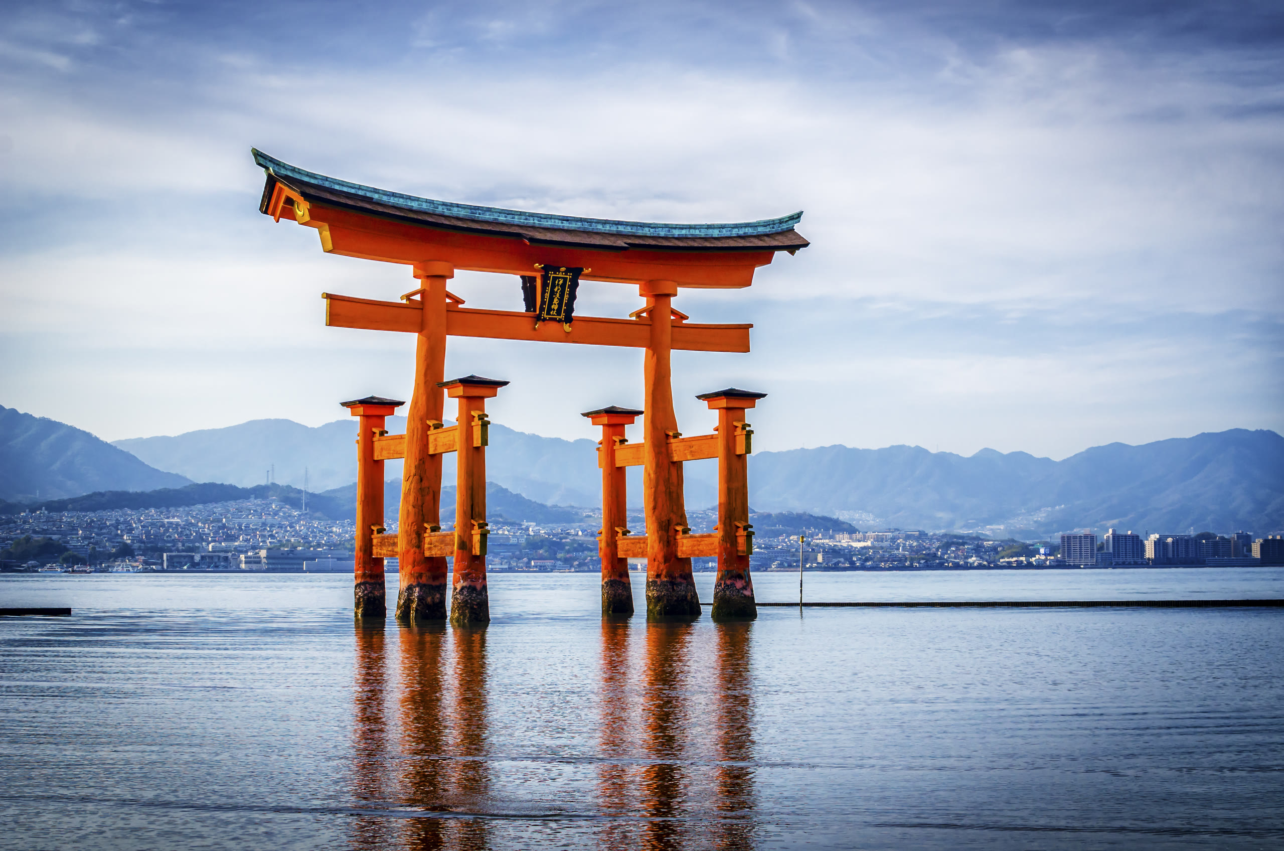 The floating torii gate of Itsukushima standing in calm water