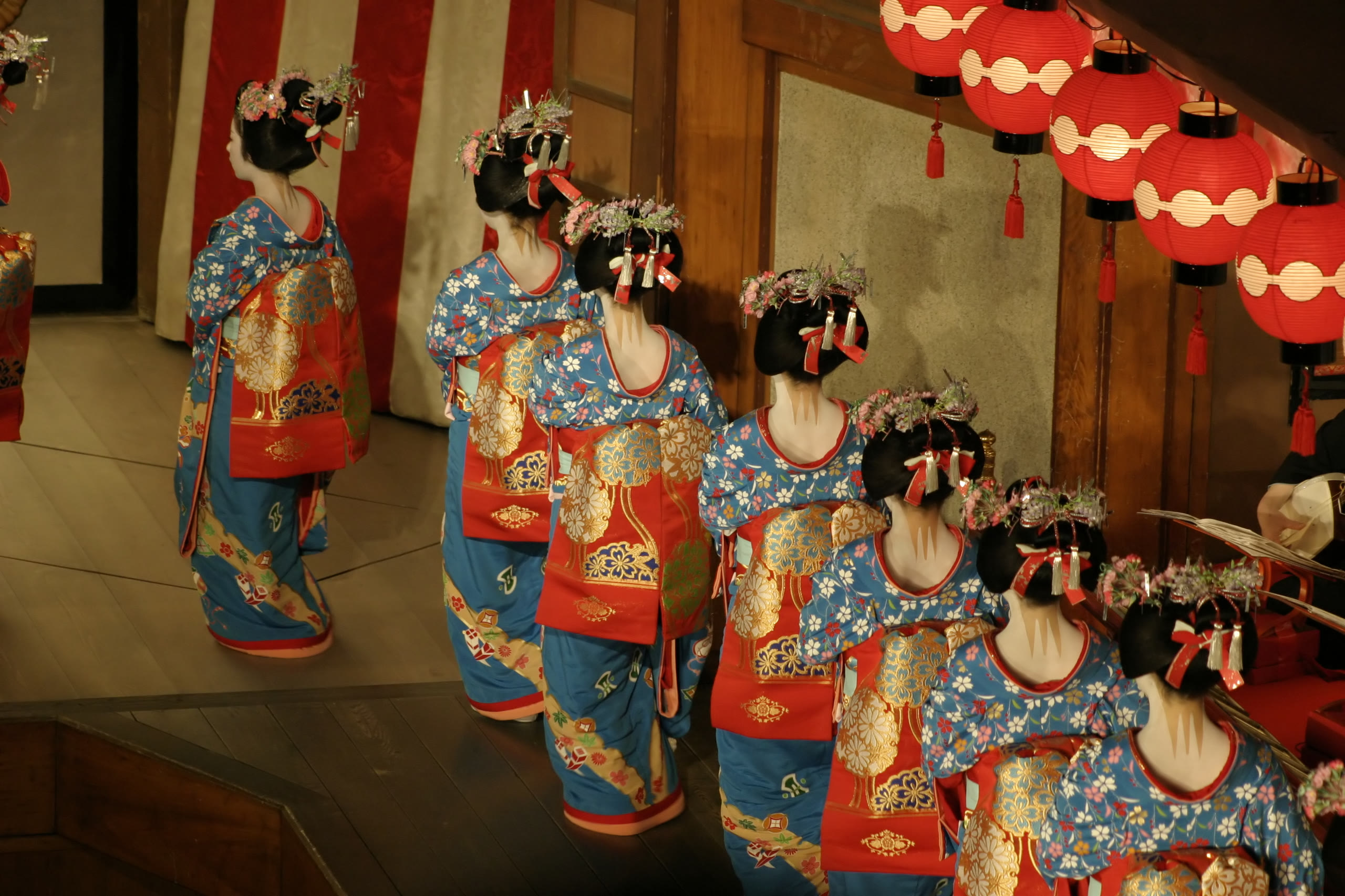 A geiko and maiko dancing in a Kamishichiken teahouse, Kyoto, by lantern light