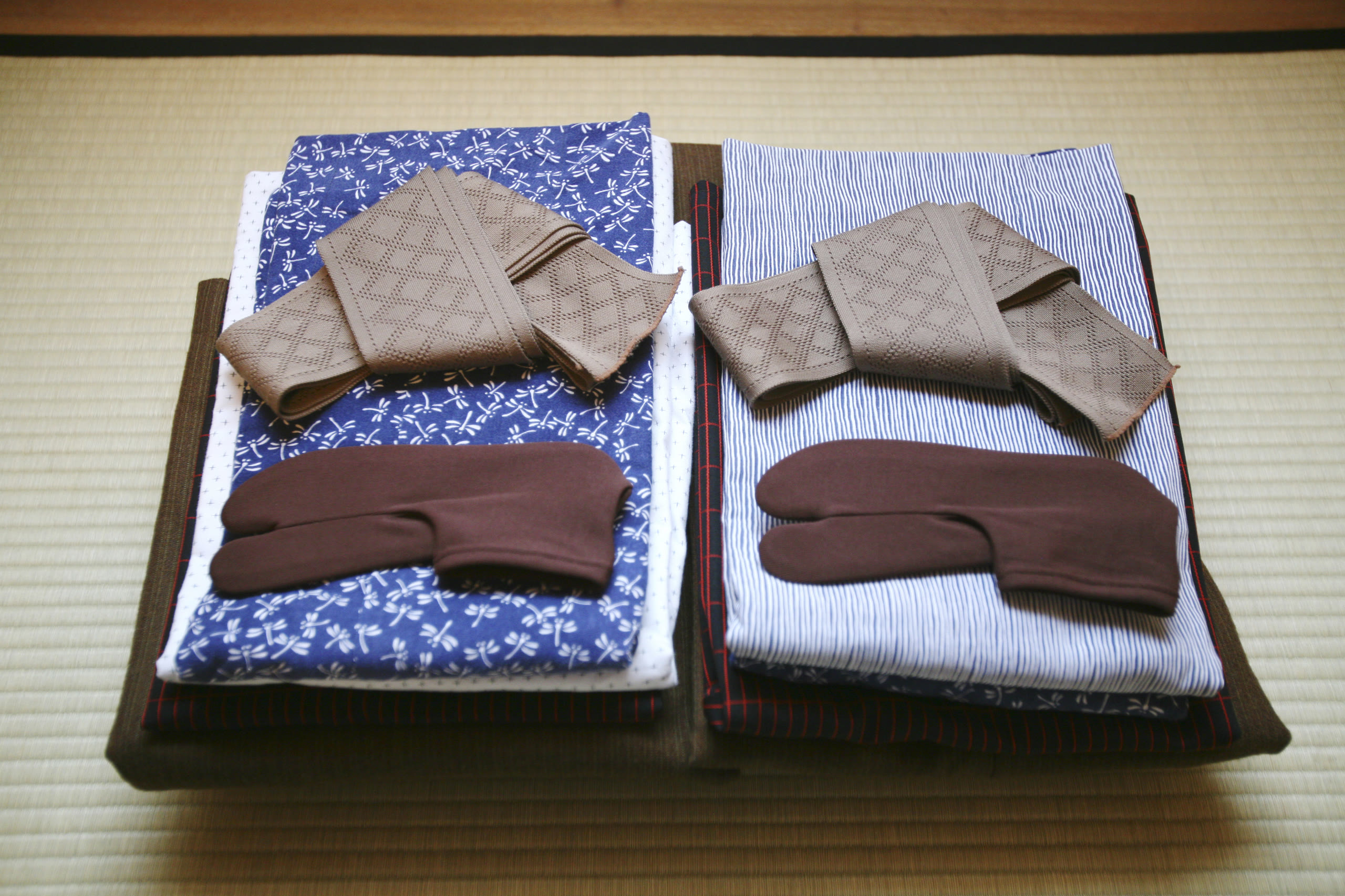 A folded yukata and travel notes laid out for the pre-journey welcome pack