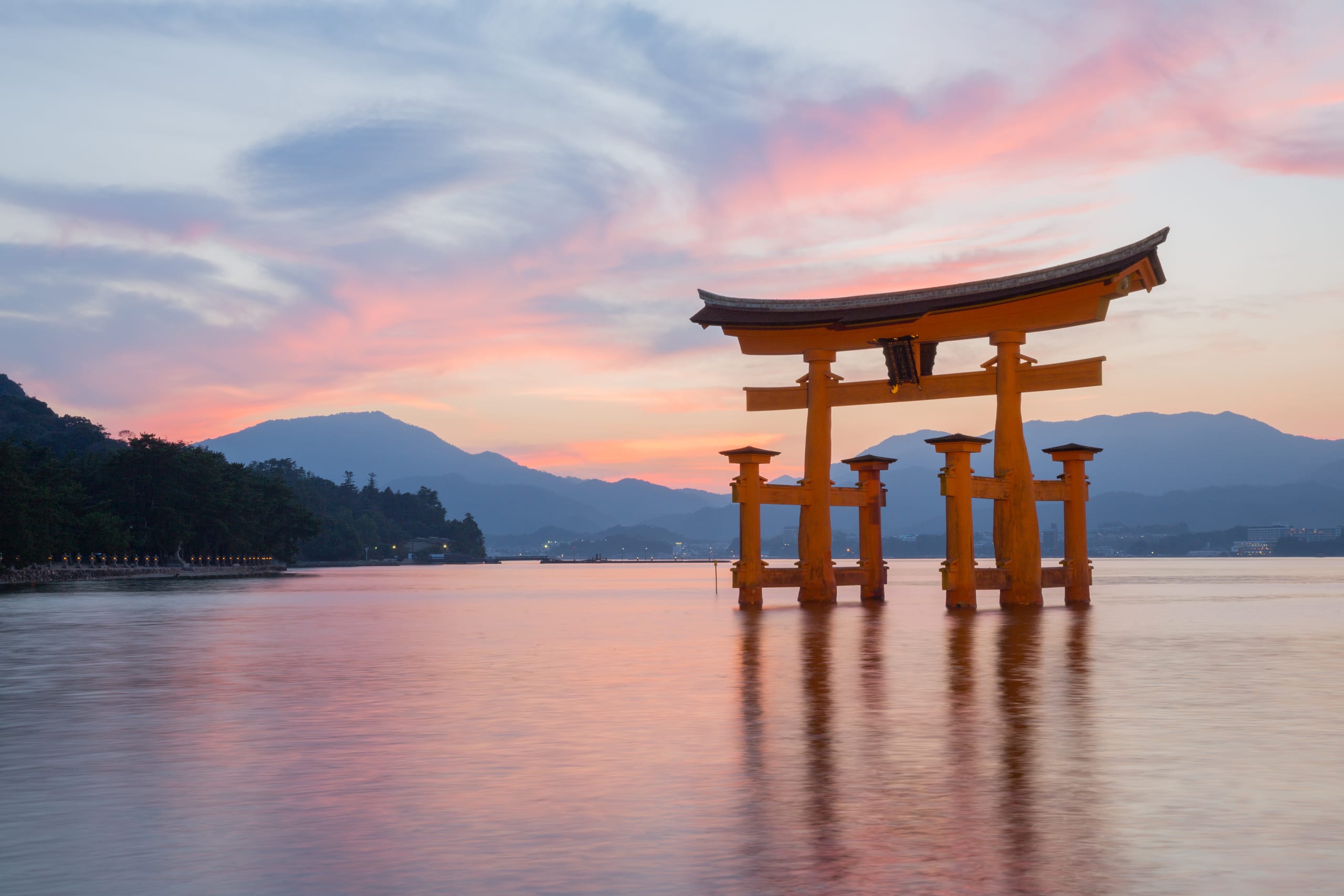 The floating torii gate of Itsukushima standing in calm water