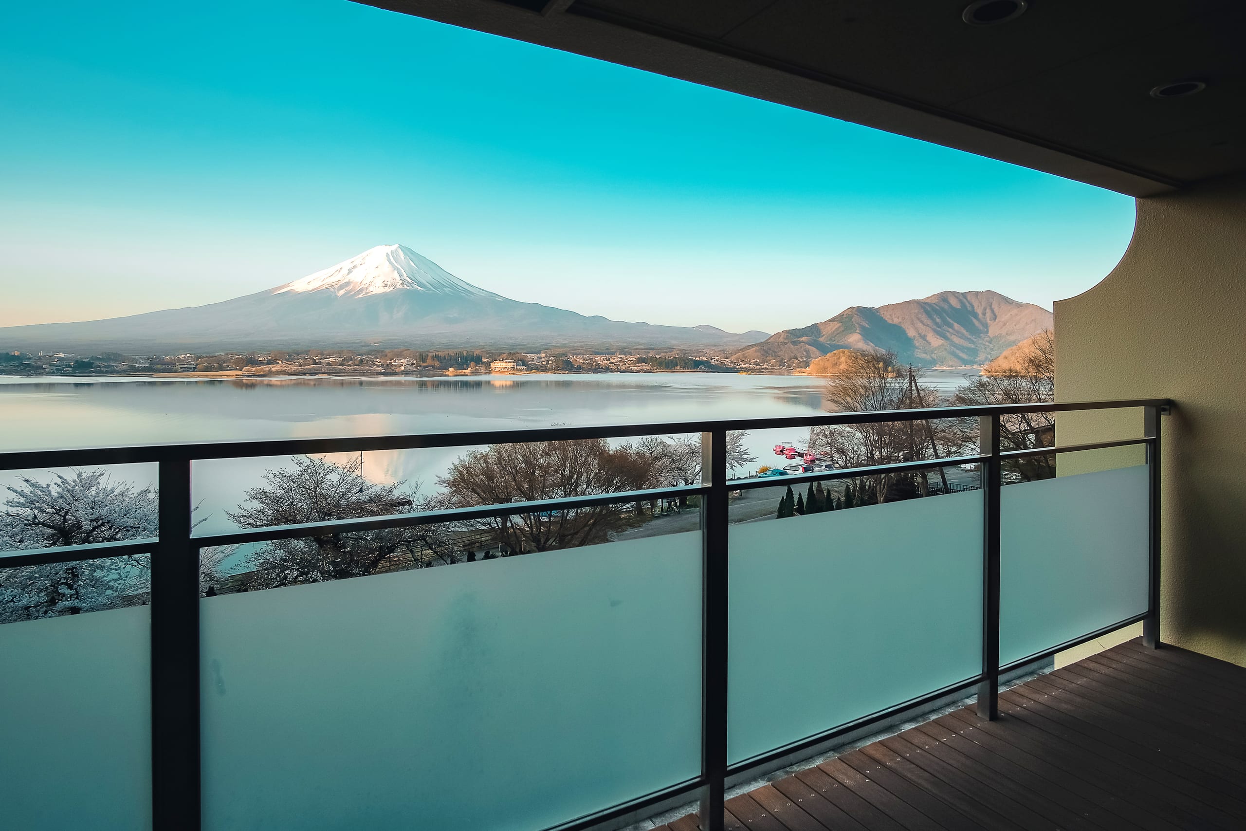 Mount Fuji seen across Lake Kawaguchiko with cherry blossom in the foreground