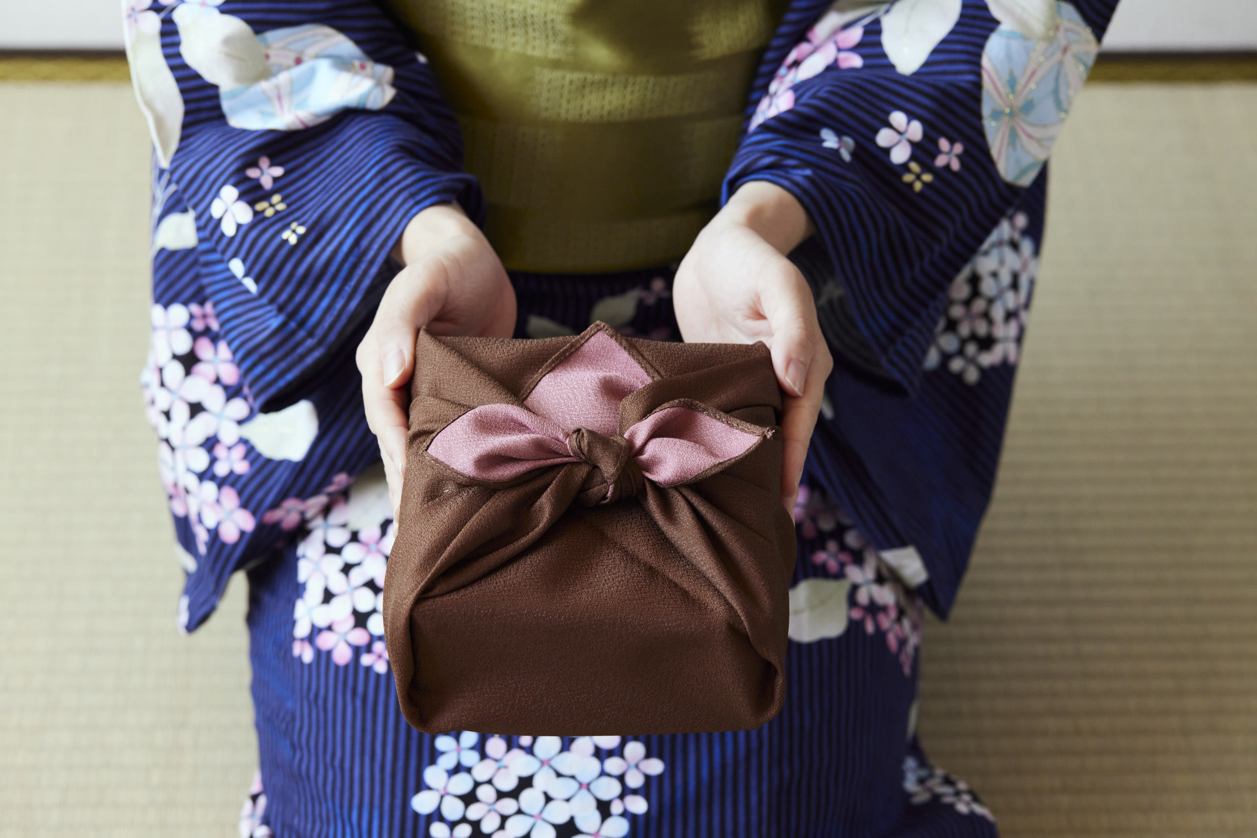 A guest in yukata on Kinosaki Onsen's willow canal
