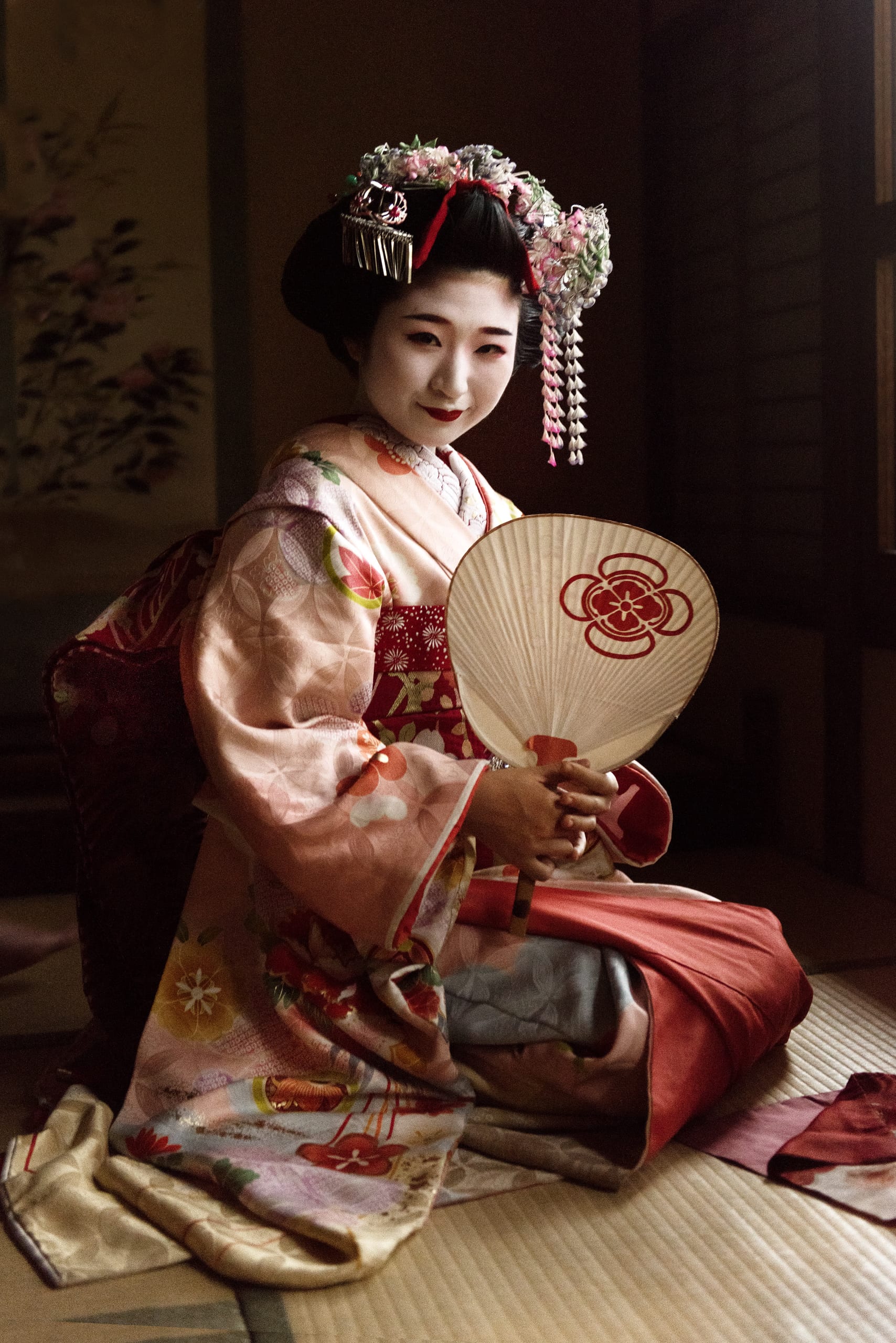 A geiko and maiko dancing in a Gion teahouse, Kyoto, by lantern light