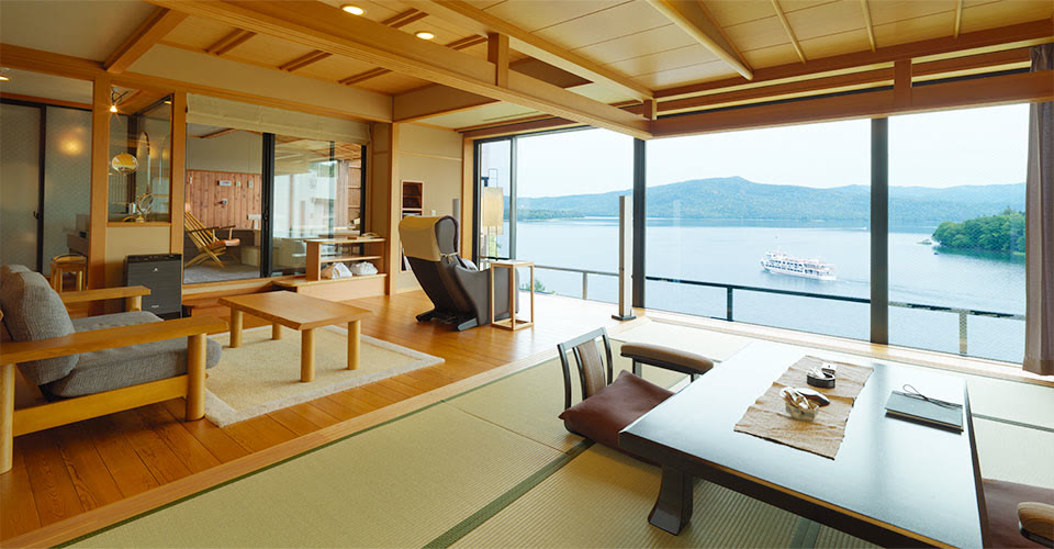 A guest room at Hinanoza with Lake Akan through the glass