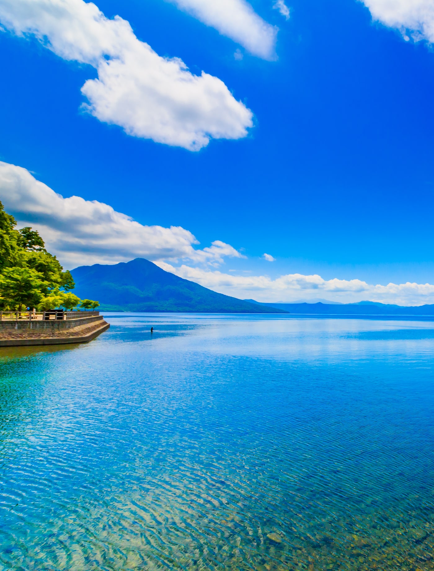 The clear turquoise water of a Hokkaido caldera lake