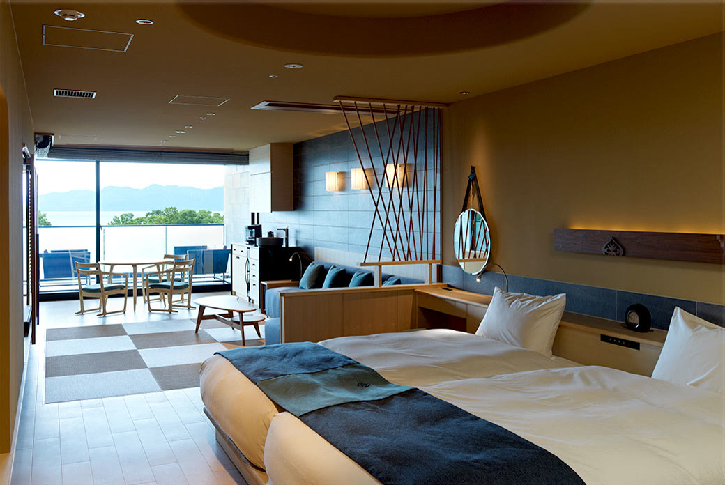 An onsen suite with a private bath facing a Hokkaido lake